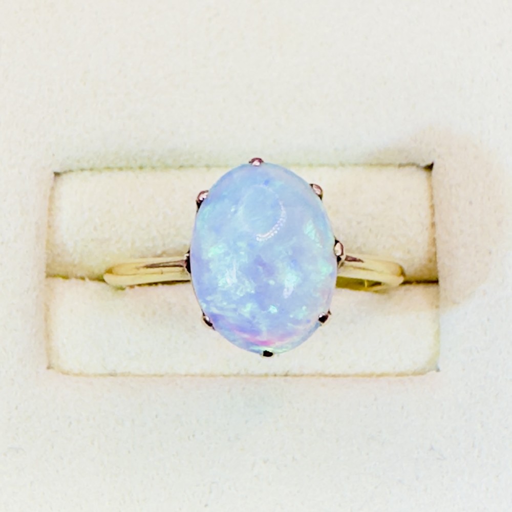 An 18ct yellow gold Victorian solitaire ring featuring an oval cabochon opal in a claw setting. View II