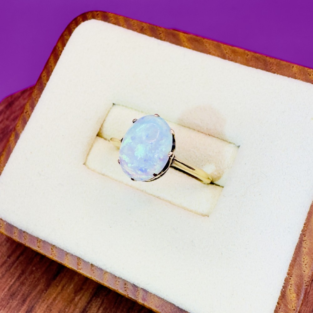An 18ct yellow gold Victorian solitaire ring featuring an oval cabochon opal in a claw setting. View III