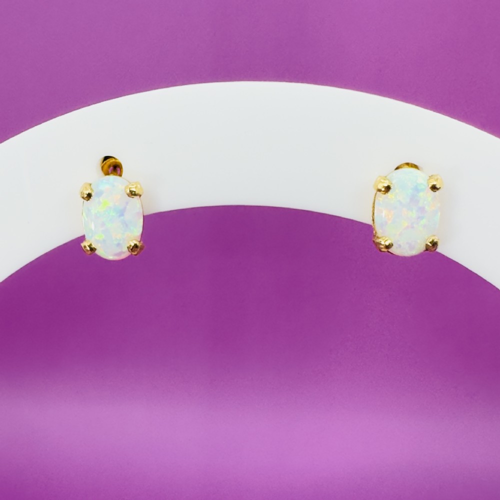 A pair of 14ct yellow gold stud earrings featuring oval-cut white opals held in four-claw settings. View XII