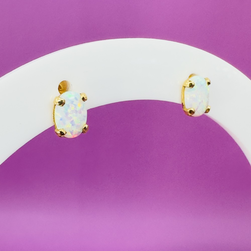 A pair of 14ct yellow gold stud earrings featuring oval-cut white opals held in four-claw settings. View XIV