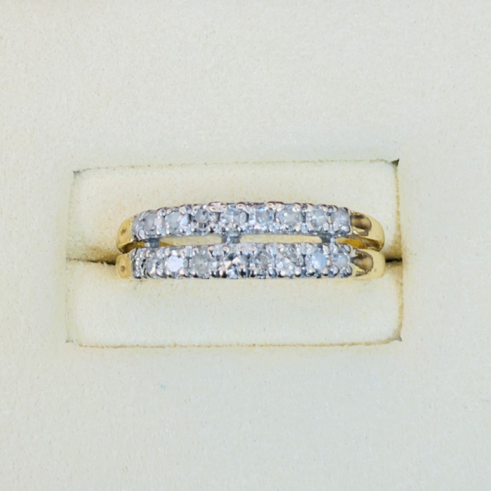 An 18ct yellow gold ring featuring a double row band set with round diamonds across the top half.