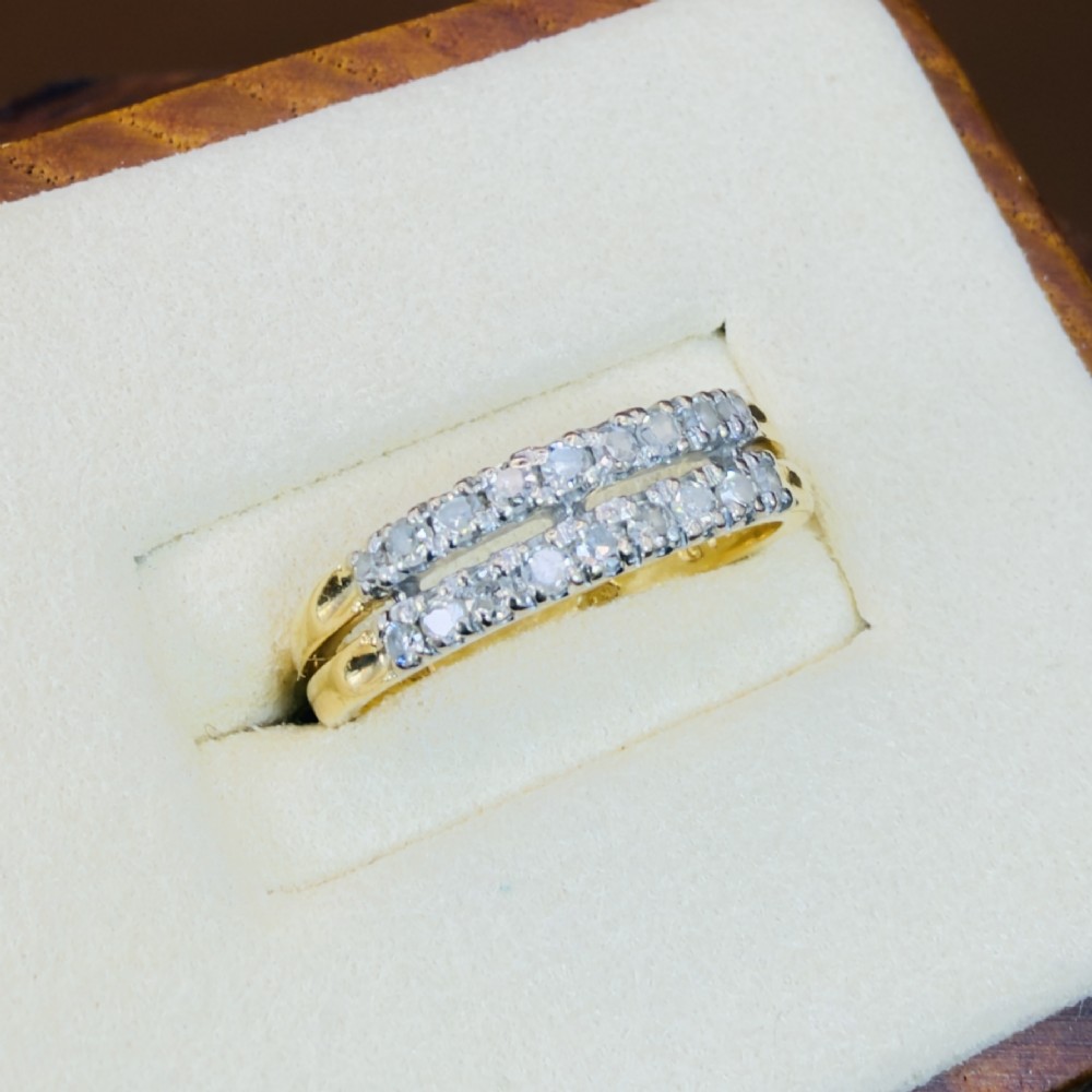 An 18ct yellow gold ring featuring a double row band set with round diamonds across the top half. View III