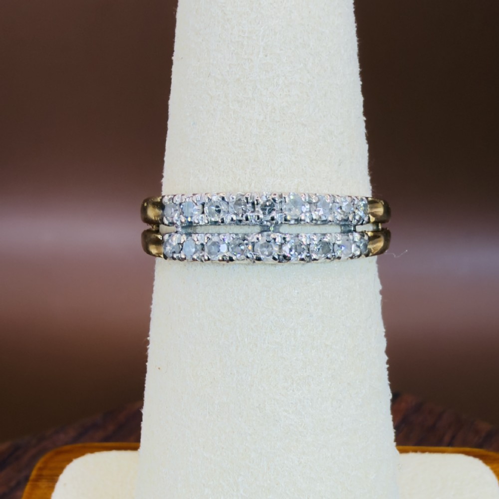 An 18ct yellow gold ring featuring a double row band set with round diamonds across the top half. View IV