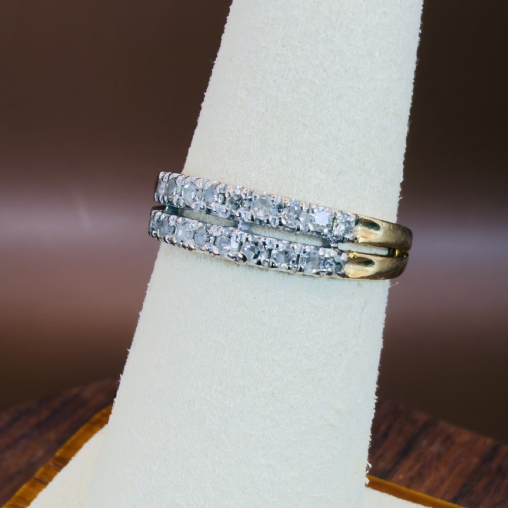 An 18ct yellow gold ring featuring a double row band set with round diamonds across the top half. View V