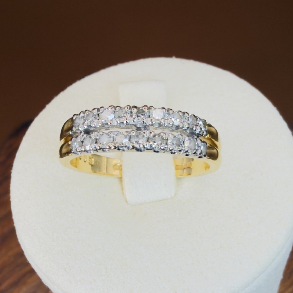 An 18ct yellow gold ring featuring a double row band set with round diamonds across the top half. View VII