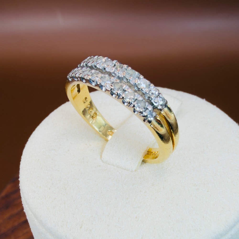An 18ct yellow gold ring featuring a double row band set with round diamonds across the top half. View VIII