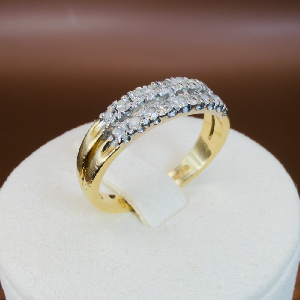 An 18ct yellow gold ring featuring a double row band set with round diamonds across the top half. View IX