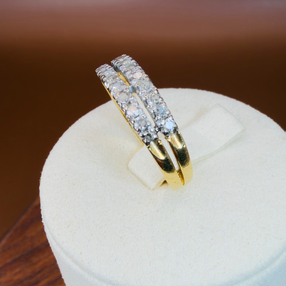 An 18ct yellow gold ring featuring a double row band set with round diamonds across the top half. View X