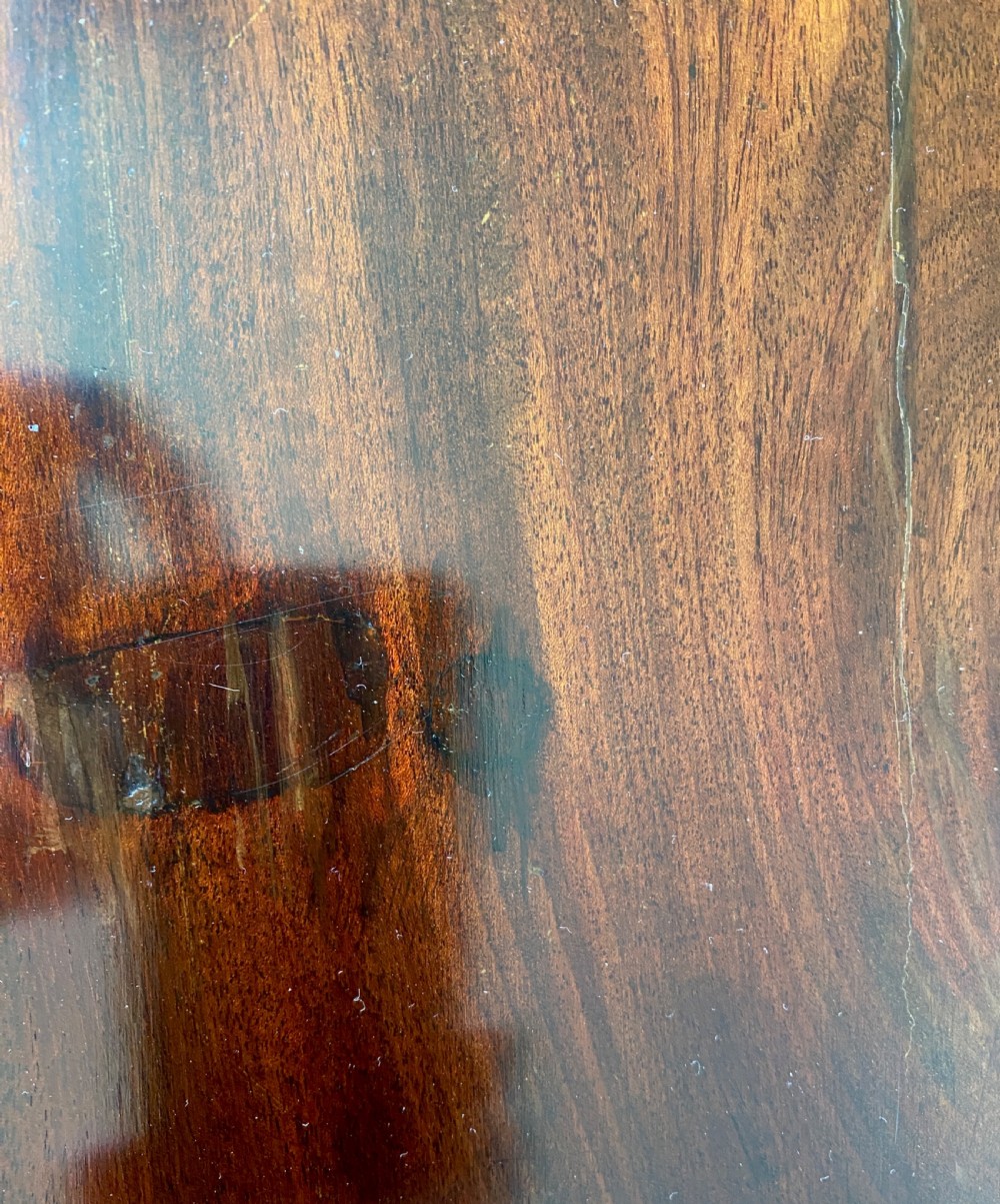 An Irish George III mahogany chest on a stand featuring a brass escutcheon, shaped apron, and carved cabriole legs. View V