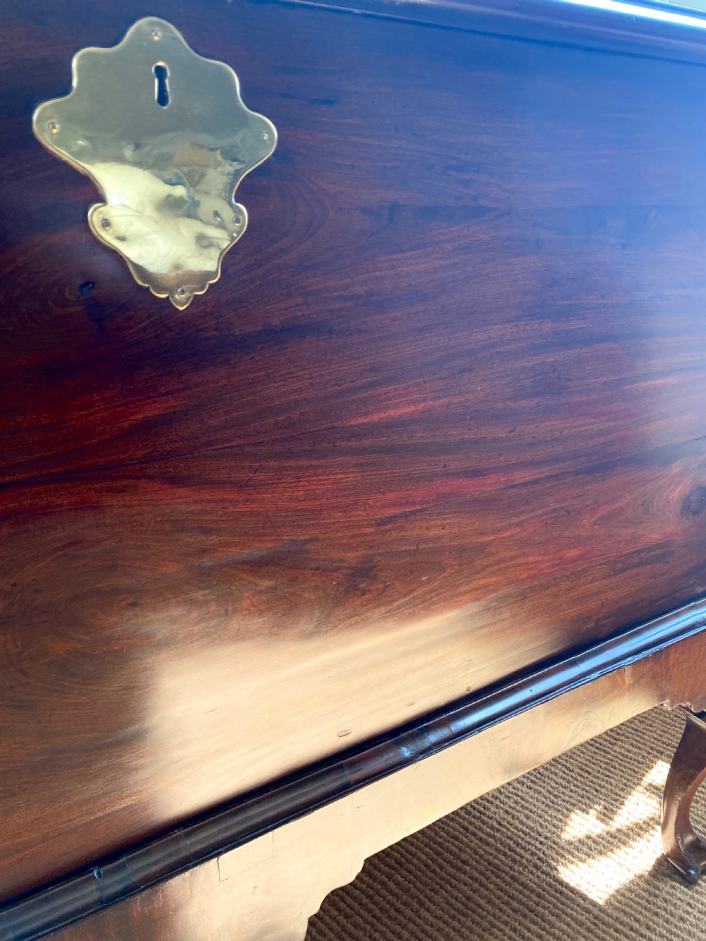 An Irish George III mahogany chest on a stand featuring a brass escutcheon, shaped apron, and carved cabriole legs. View VIII