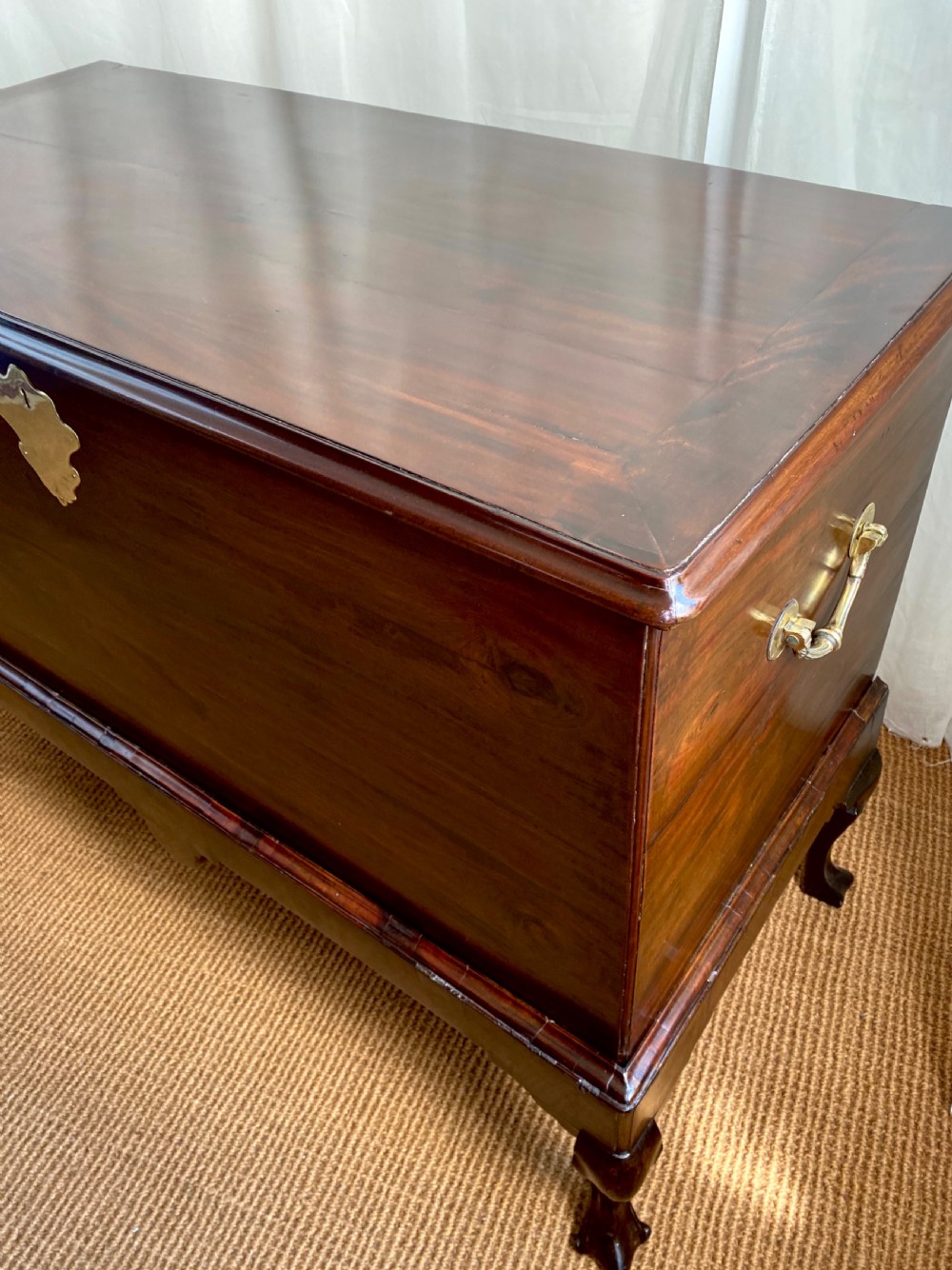 An Irish George III mahogany chest on a stand featuring a brass escutcheon, shaped apron, and carved cabriole legs. View VI