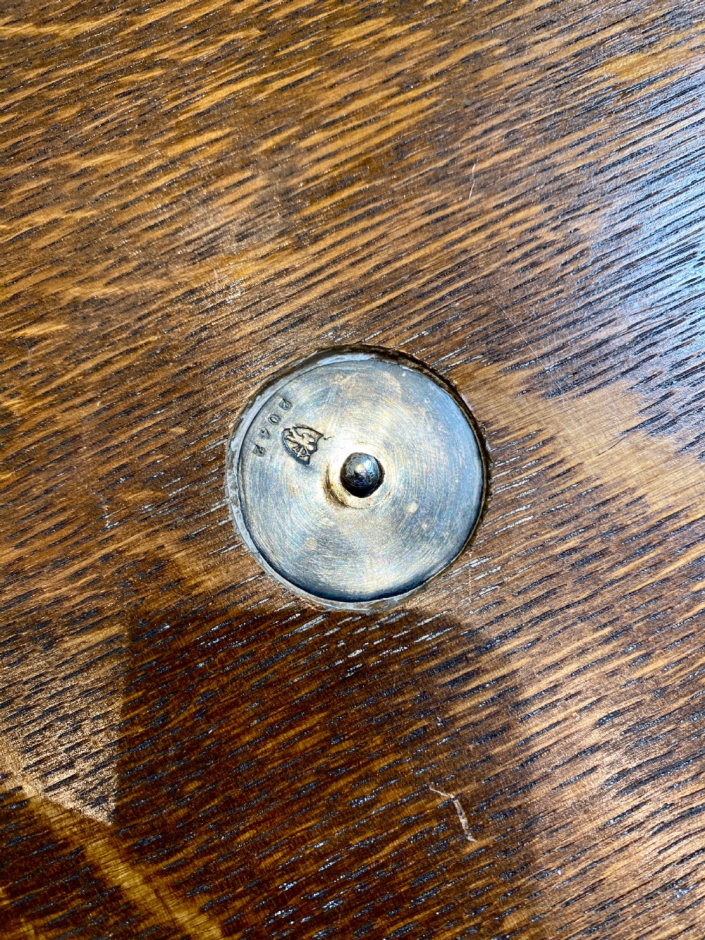An oval 19th-century quarter-sawn oak gallery tray featuring a pierced silver-plated rim, central engraved shield plaque, and side carrying handles. View V