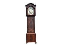 A tall mahogany longcase clock featuring a swan-neck pediment hood and an arched dial displaying moon phase details.