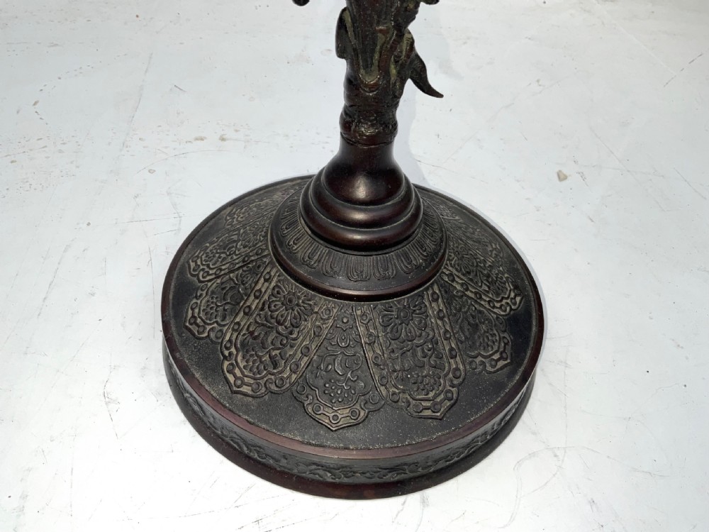 A Victorian dark bronze tabletop dinner gong featuring relief carving and a sculpted figure mounted atop a circular pedestal base. View IV