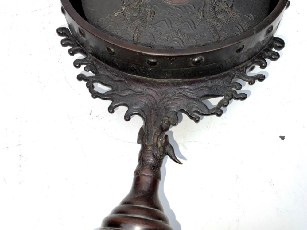 A Victorian dark bronze tabletop dinner gong featuring relief carving and a sculpted figure mounted atop a circular pedestal base. View XII