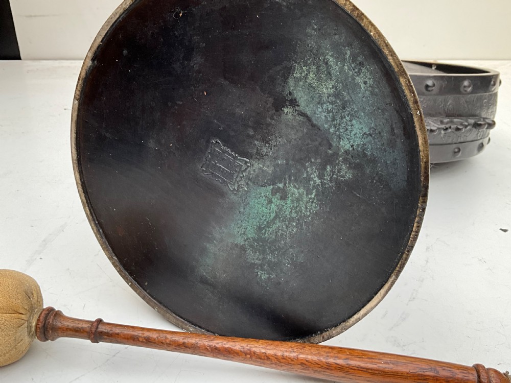 A Victorian dark bronze tabletop dinner gong featuring relief carving and a sculpted figure mounted atop a circular pedestal base. View XV