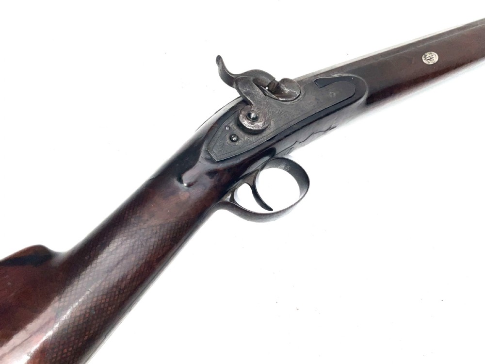 An antique nineteenth-century single-barrel percussion fowler featuring a dark polished walnut stock, steel trigger guard, and long smoothbore barrel. View III
