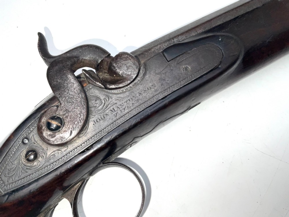 An antique nineteenth-century single-barrel percussion fowler featuring a dark polished walnut stock, steel trigger guard, and long smoothbore barrel. View IV