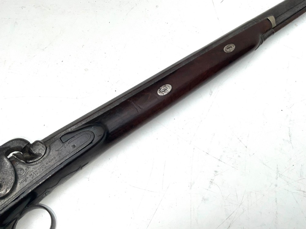 An antique nineteenth-century single-barrel percussion fowler featuring a dark polished walnut stock, steel trigger guard, and long smoothbore barrel. View V