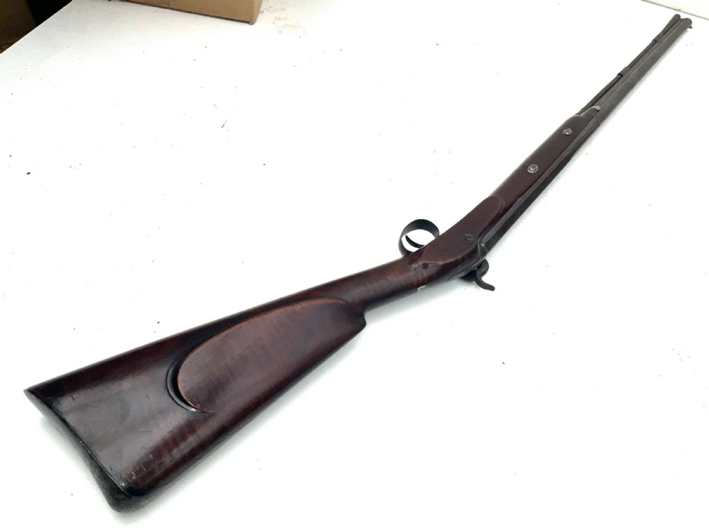 An antique nineteenth-century single-barrel percussion fowler featuring a dark polished walnut stock, steel trigger guard, and long smoothbore barrel. View VII