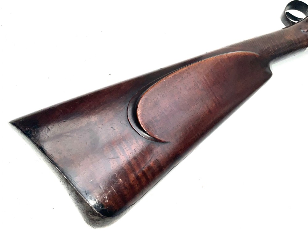 An antique nineteenth-century single-barrel percussion fowler featuring a dark polished walnut stock, steel trigger guard, and long smoothbore barrel. View VIII