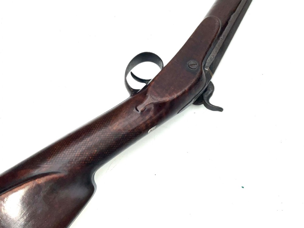 An antique nineteenth-century single-barrel percussion fowler featuring a dark polished walnut stock, steel trigger guard, and long smoothbore barrel. View IX