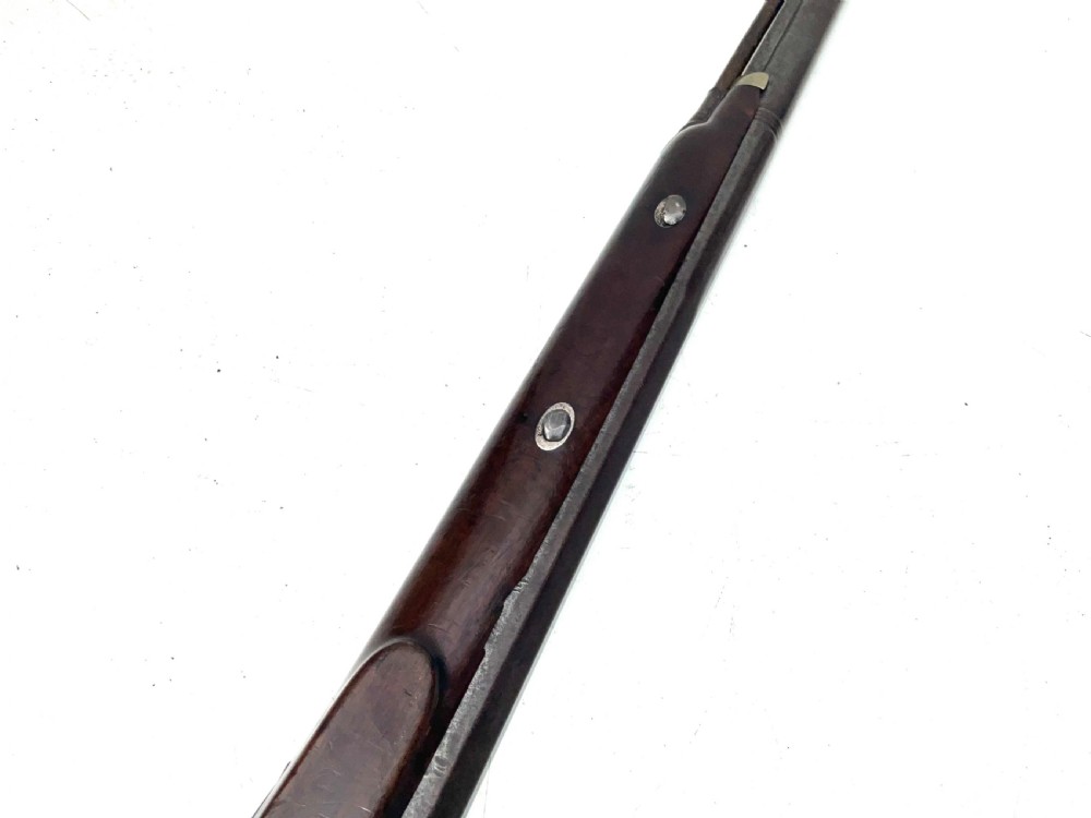 An antique nineteenth-century single-barrel percussion fowler featuring a dark polished walnut stock, steel trigger guard, and long smoothbore barrel. View X