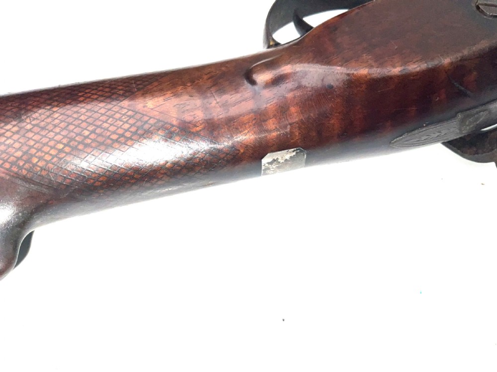 An antique nineteenth-century single-barrel percussion fowler featuring a dark polished walnut stock, steel trigger guard, and long smoothbore barrel. View XIII
