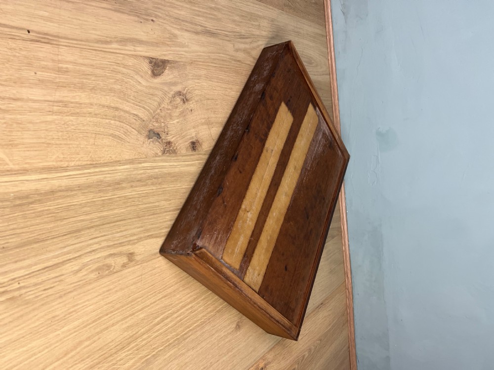 An antique dark mahogany Canterbury featuring a slatted grid-style upper compartment above a single base drawer with turned legs and brass castors. View X