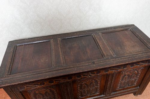 EARLY OAK COFFER WITH ORIGINAL PANELLED TOP AND WONDERFUL CARVED PANEL FRONT - ADDITIONAL PHOTO 1
