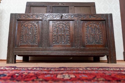 EARLY OAK COFFER WITH ORIGINAL PANELLED TOP AND WONDERFUL CARVED PANEL FRONT - ADDITIONAL PHOTO 6
