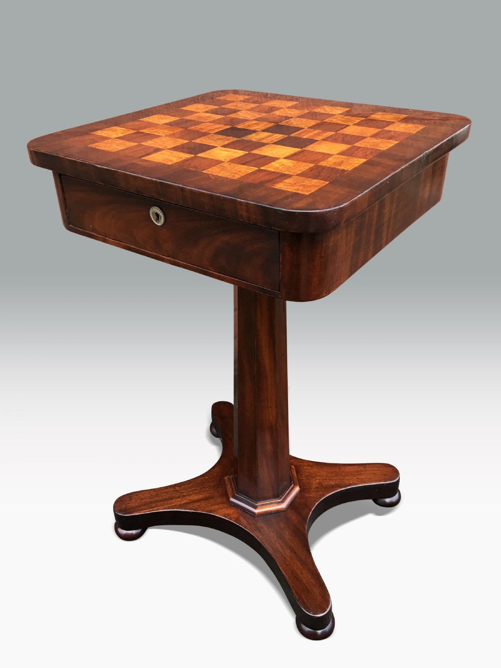 AN EARLY VICTORIAN MAHOGANY GAMES TABLE.