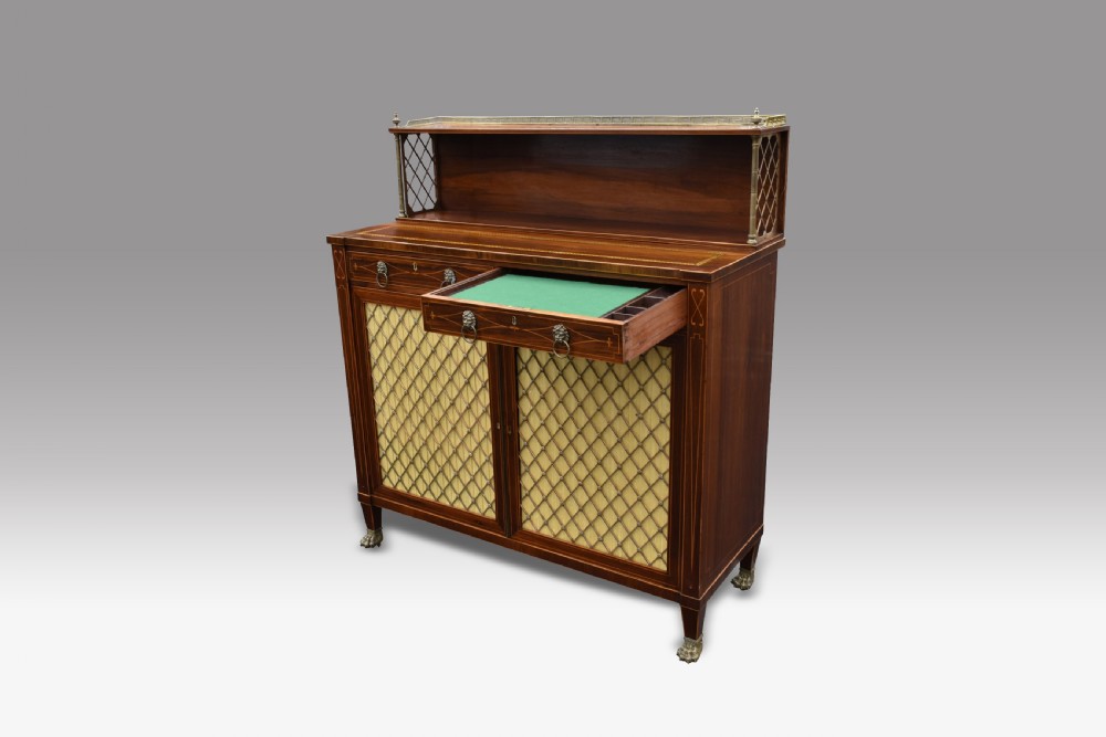 A Regency rosewood chiffonier featuring boxwood inlay, a top shelf with brass gallery and lattice sides, brass grille doors, lion mask handles, and a pull-out fitted writing drawer. View V