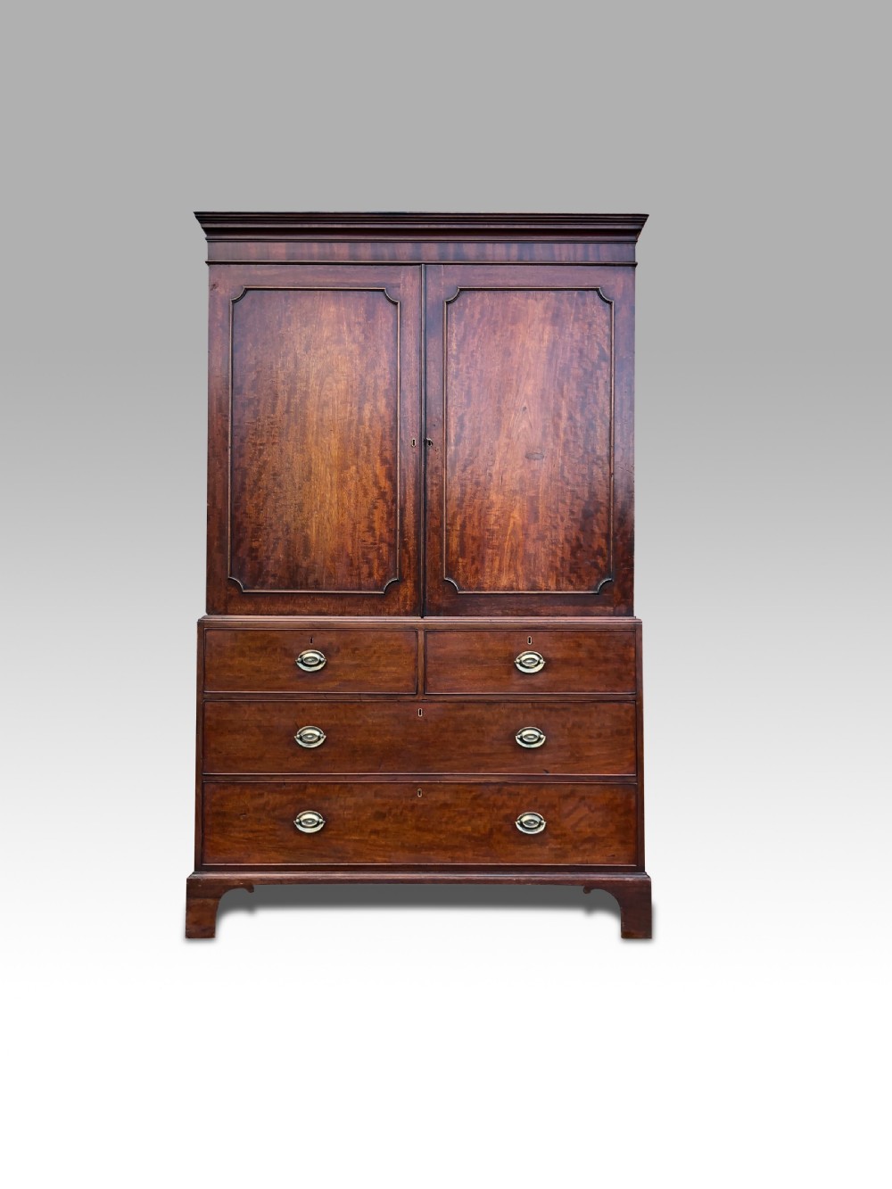 A GEORGE III MAHOGANY LINEN PRESS