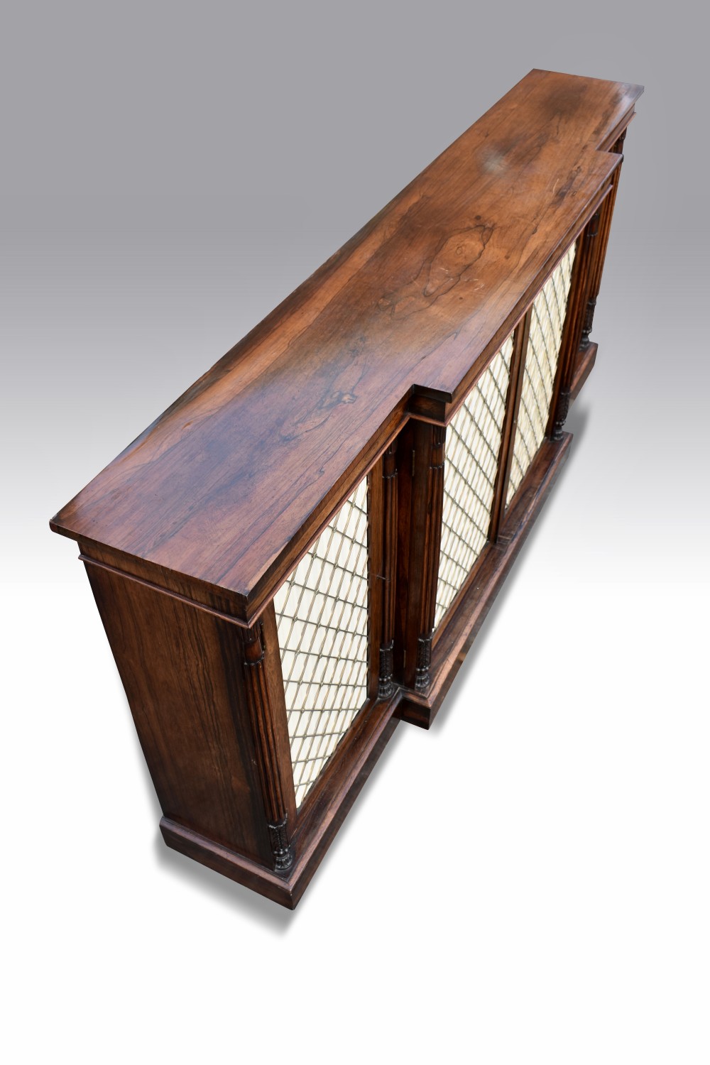 A MAGNIFICENT LATE REGENCY ROSEWOOD BREAKFRONT SIDE CABINET IN THE MANNER OF GILLOWS. View II