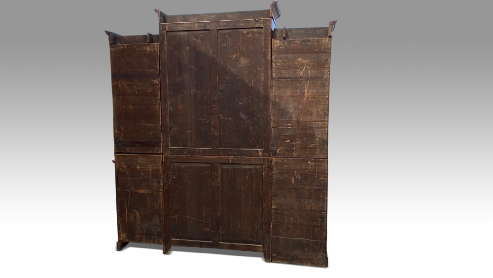 A George III mahogany breakfront secretaire bookcase with geometric astragal glazing, a fitted drop-down writing section, and flame mahogany panel doors. View VI