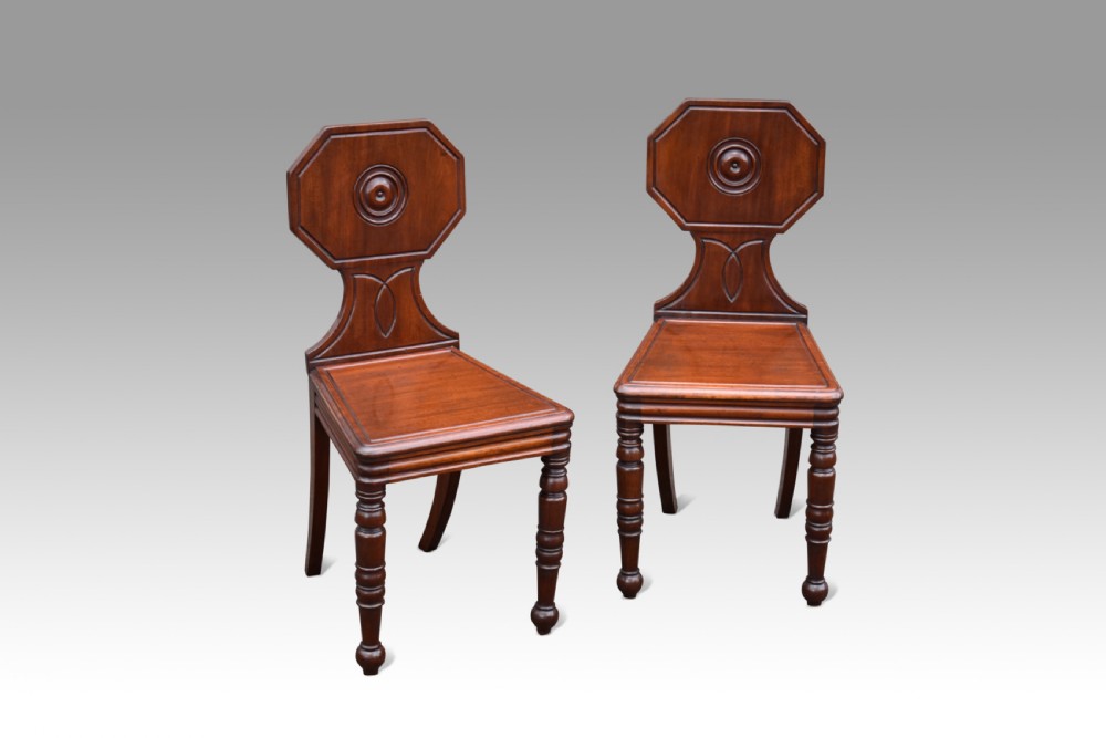 Pair of Regency mahogany hall chairs.