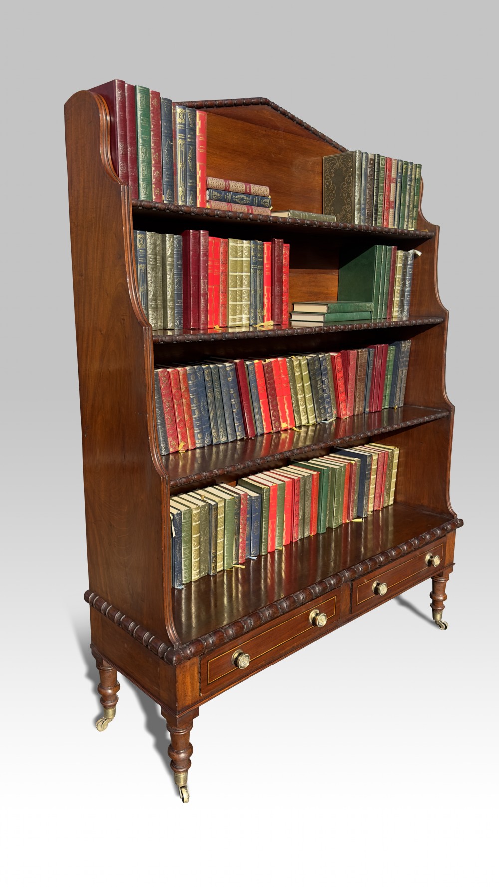 A FINE IRISH REGENCY MAHOGANY WATERFALL OPEN BOOKCASE.
