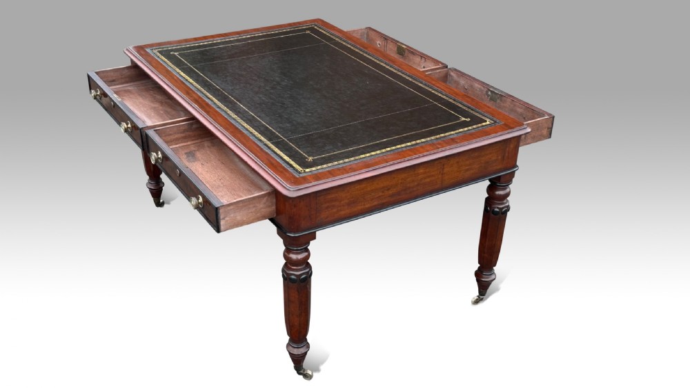 A pair of antique Regency mahogany armchairs featuring curved top rails with ebonised stringing, sweeping scroll armrests, cream upholstered seats, and turned front legs. View III