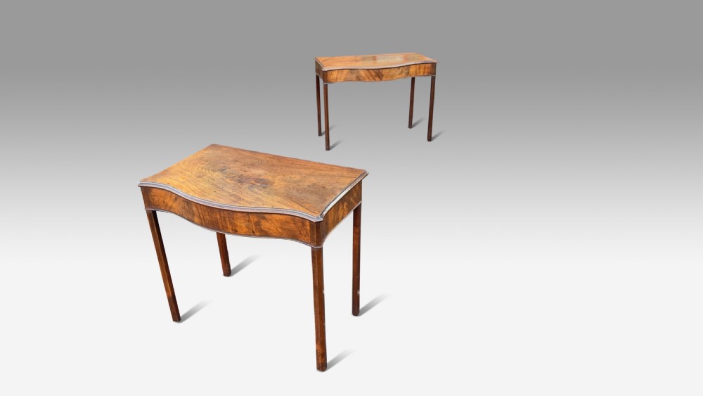 A pair of George III mahogany side tables featuring serpentine fronts and straight square legs. View II