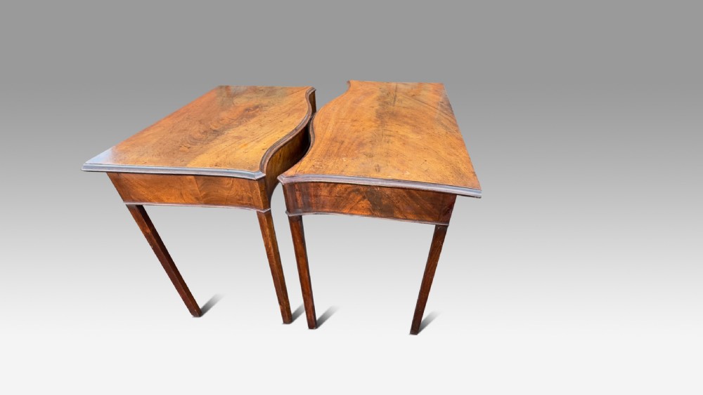 A pair of George III mahogany side tables featuring serpentine fronts and straight square legs. View III