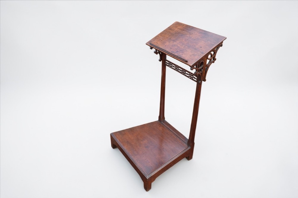 An 18th-century mahogany prie-dieu featuring a slanted top surface, decorative carved pierced fretwork brackets, twin vertical supports, and a flat kneeling base. View II