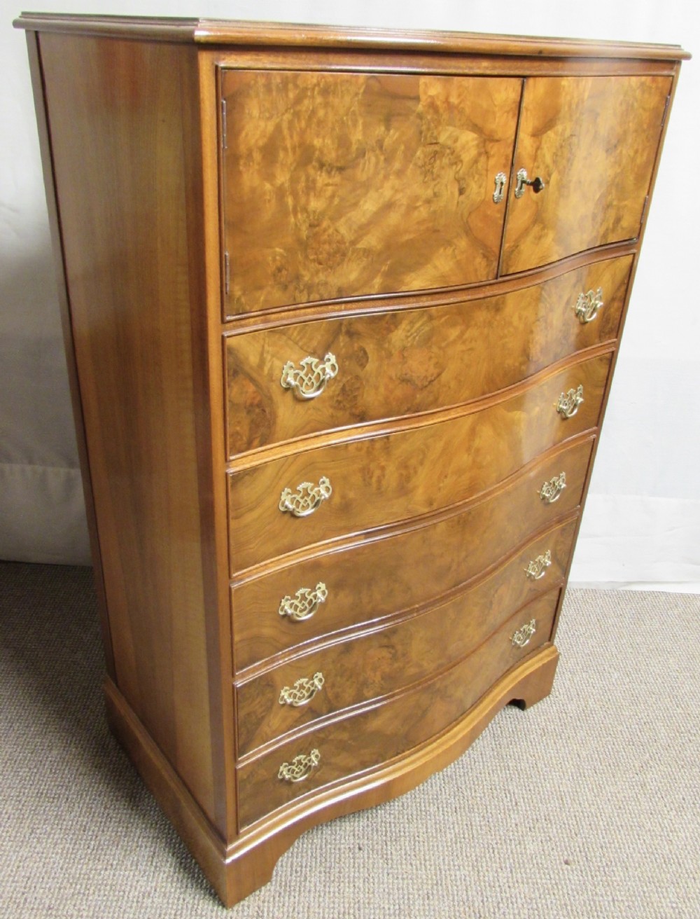 Burr Walnut Serpentine Chest of Drawers with Cupboard Over.