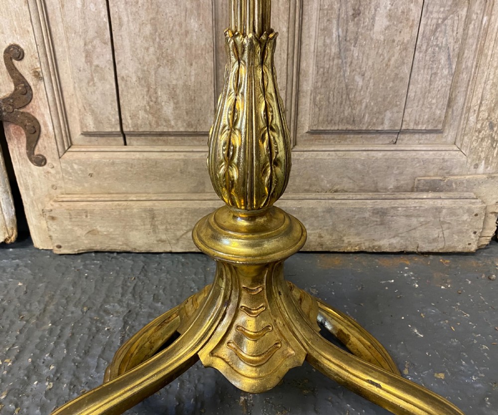 A French brass standard lamp featuring a fluted column shaft, scroll tripod base, and a white opal glass shade. View IV