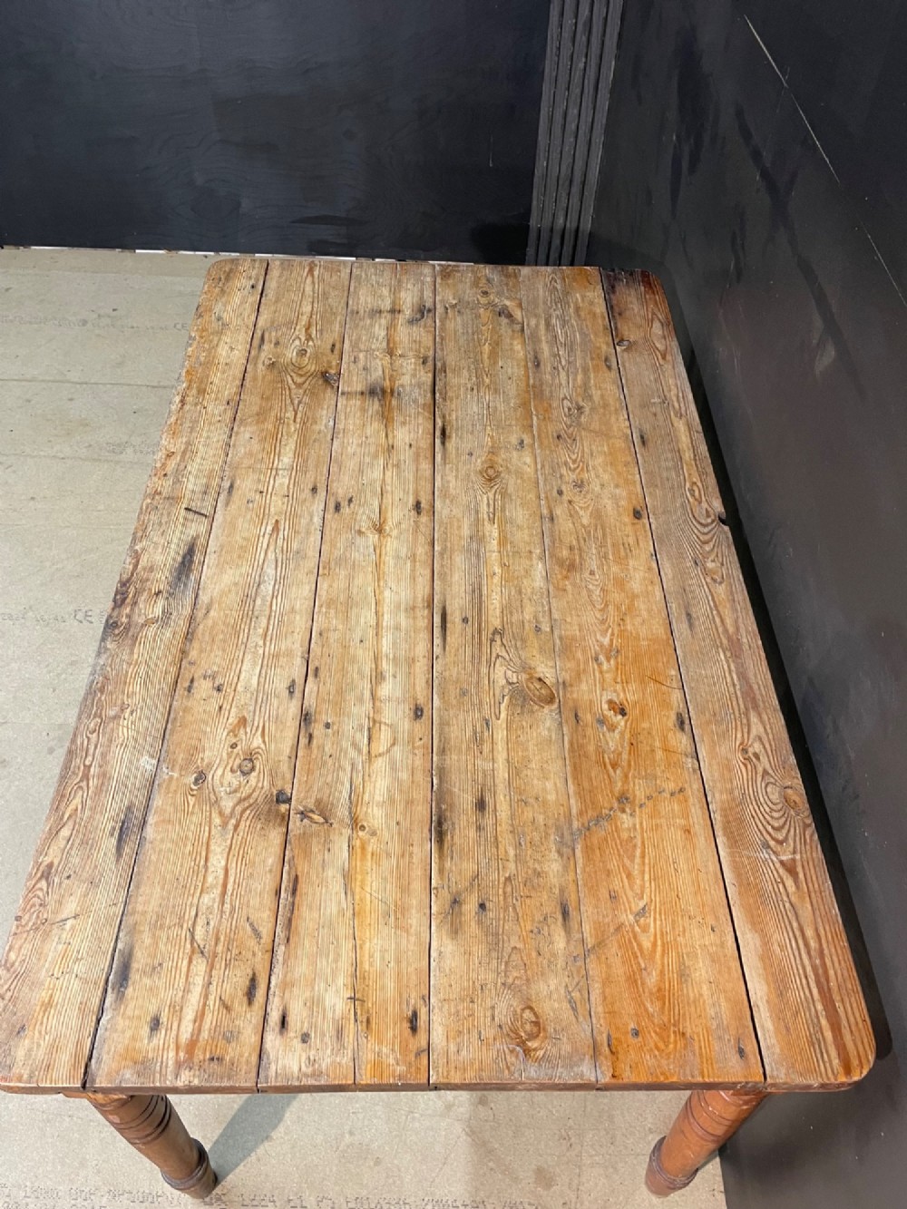 A rectangular pine farmhouse dining table with turned wooden legs and a planked top. View III