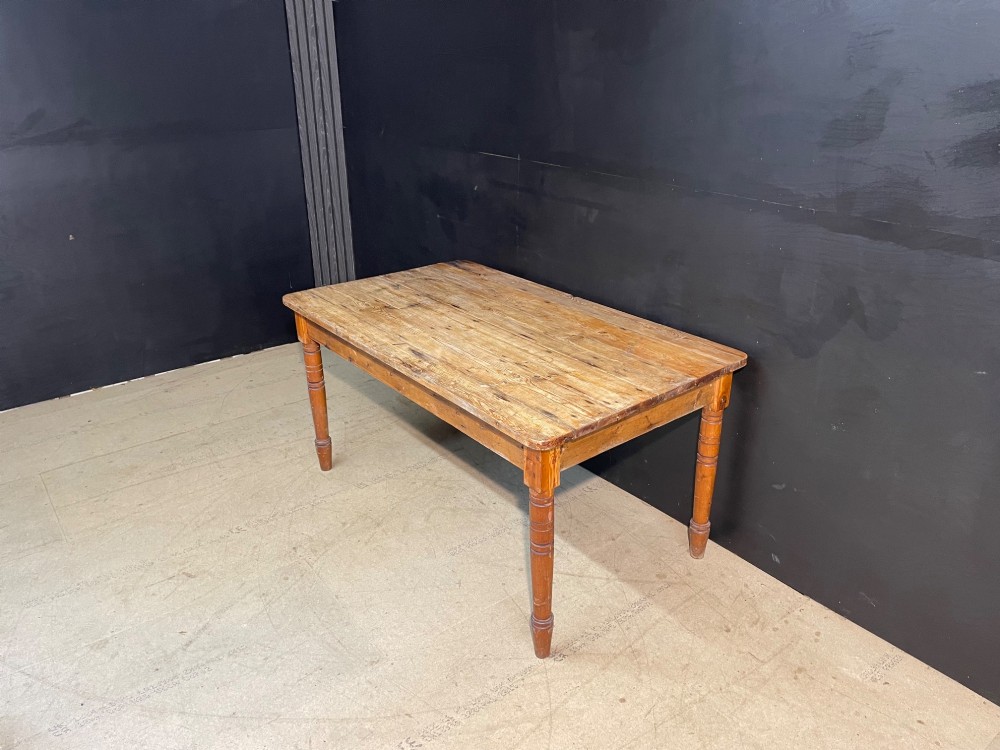 A rectangular pine farmhouse dining table with turned wooden legs and a planked top. View VII