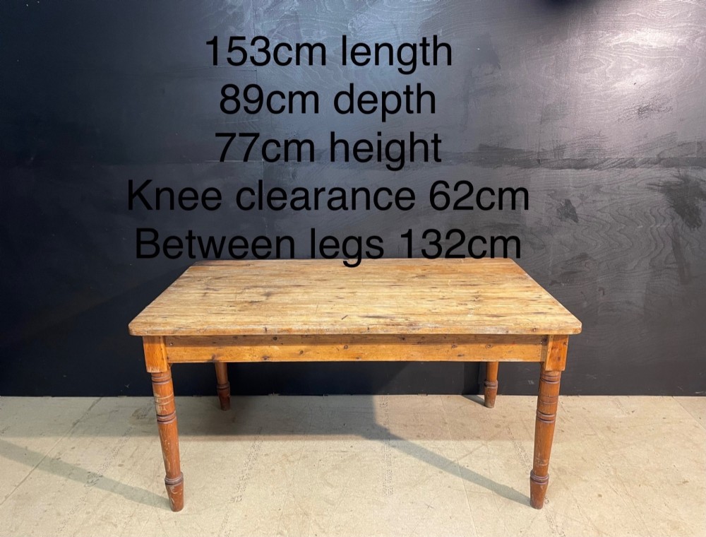 A rectangular pine farmhouse dining table with turned wooden legs and a planked top. View XI