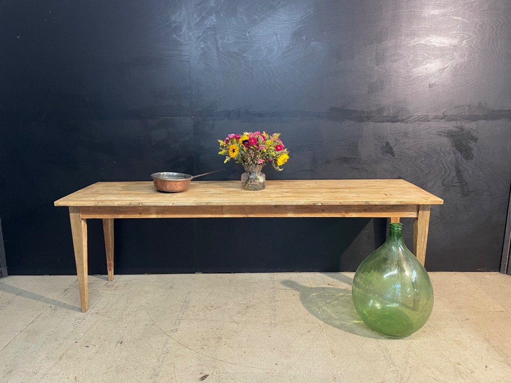 A long scrubbed pine dining table featuring a planked top surface and four tapered square legs. View XI