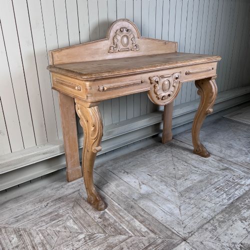 fig 1. A Victorian carved pine console table featuring front cabriole legs, a central relief cartouche, and a shaped gallery backrest.
