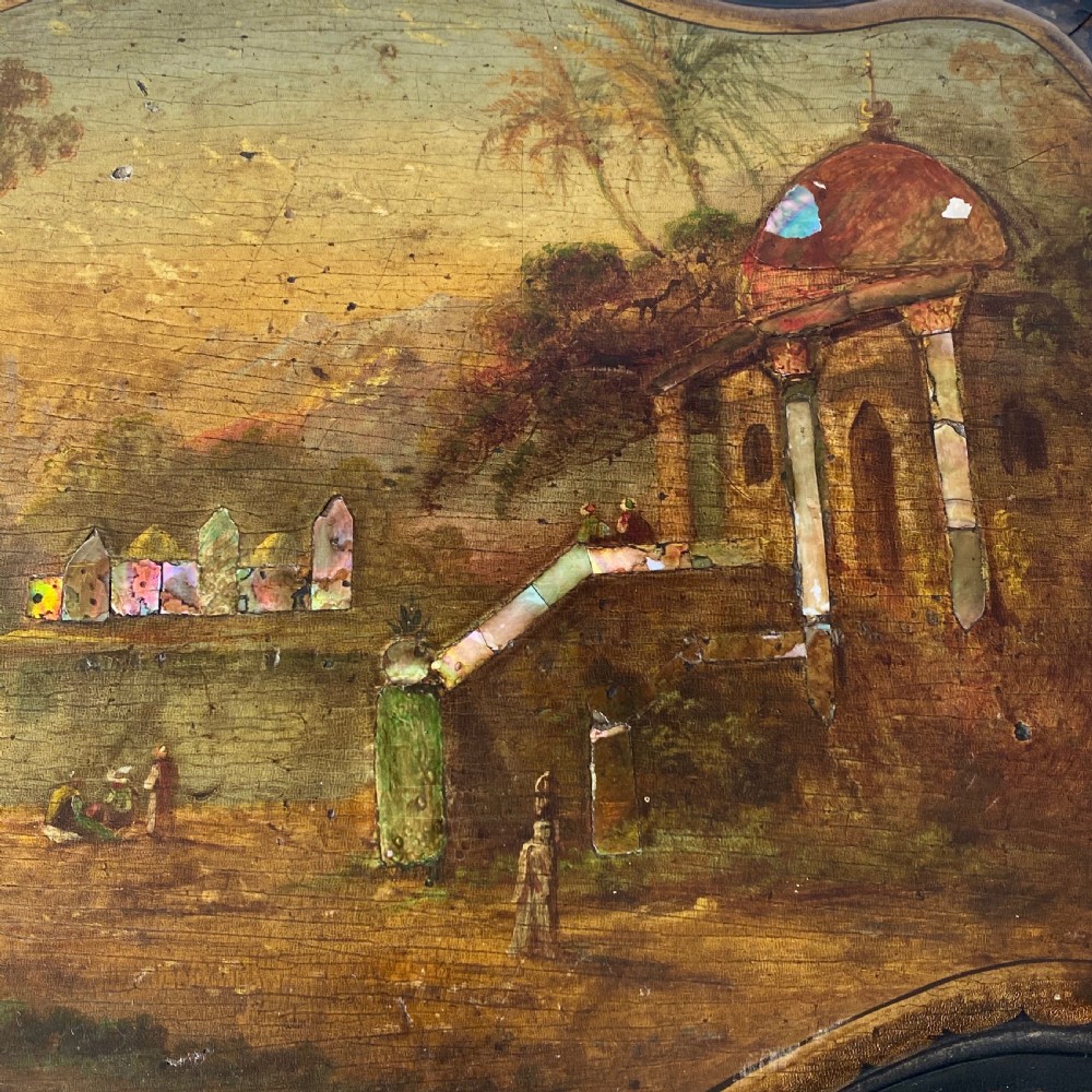 A Victorian ebonised black wooden sewing table featuring hand-painted floral designs, a painted landscape scene on the lid, cabriole legs, and a lower undertier. View XIV